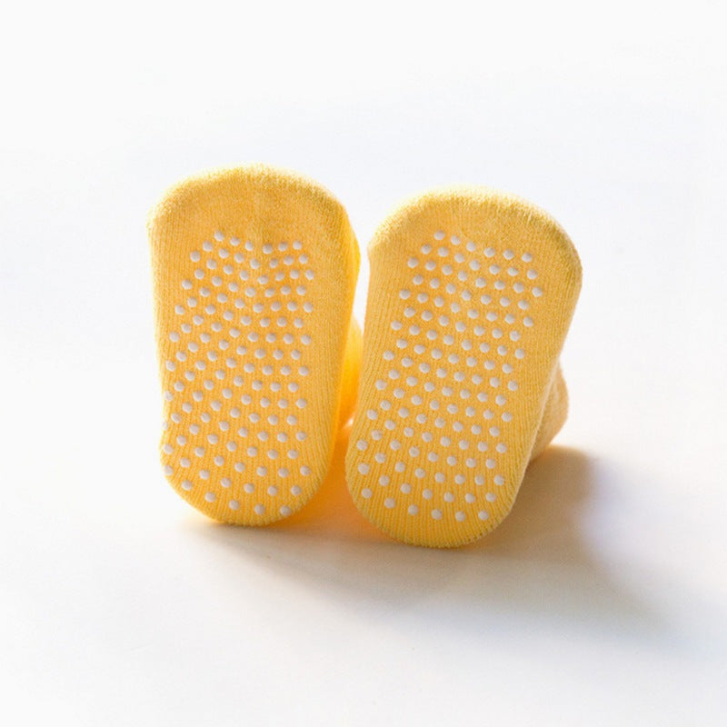 Yellow baby anti-slip socks underneath