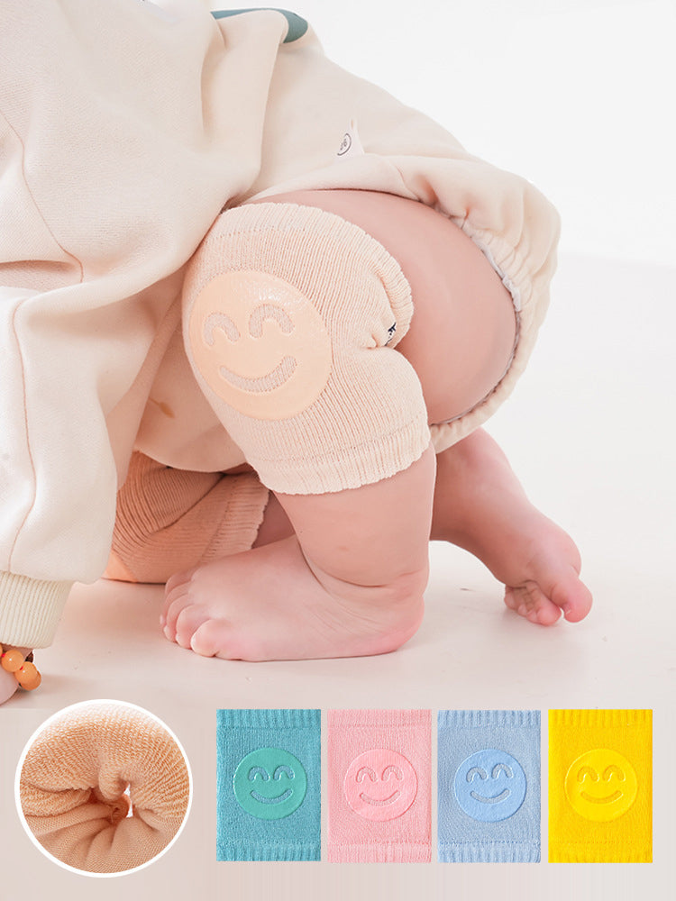 Beige baby knee pads on baby knees
