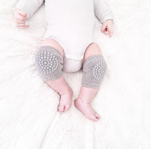 Grey baby knee pads on baby