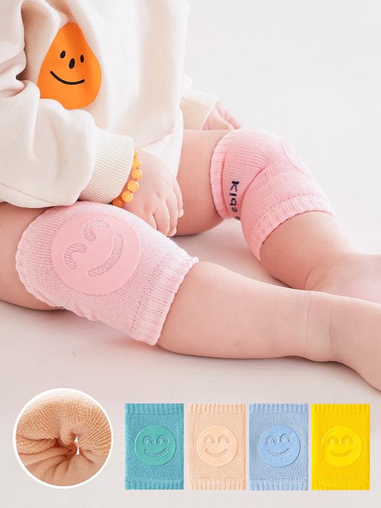 Grey baby knee pads on baby knees